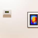 Wifi enabled thermostat on a wall with framed modern art, for the web