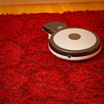 robot vaccuum cleaner on a bright red shag carpet